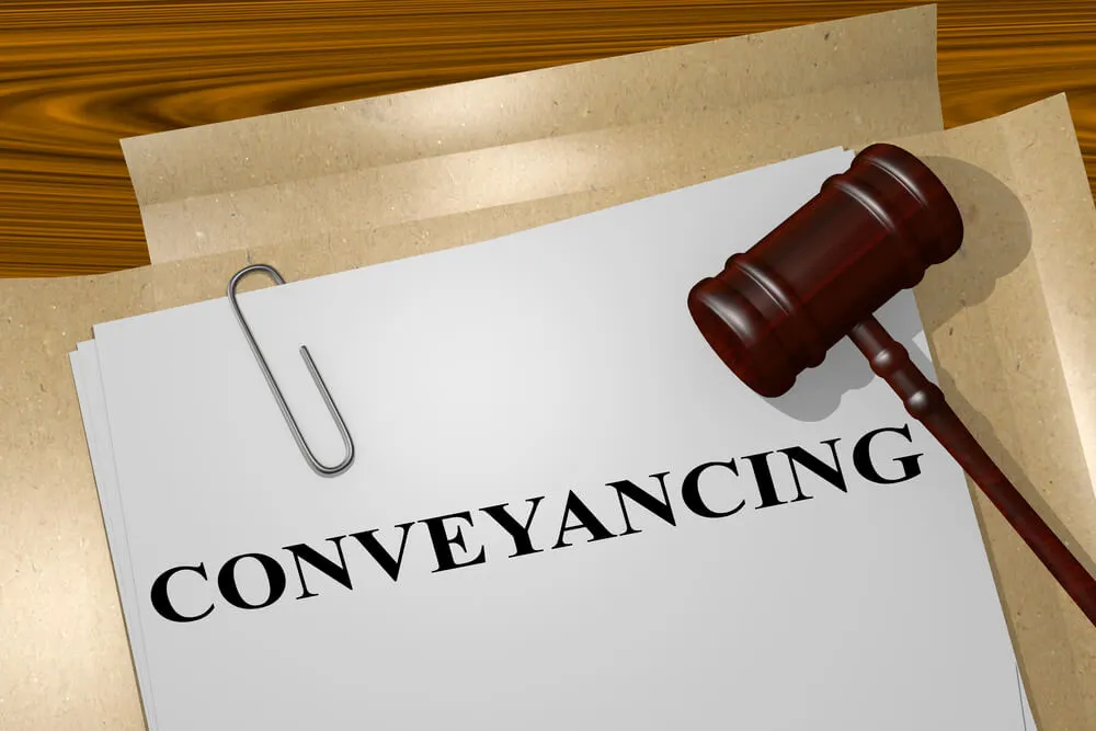 Conveyancing Text on White Paper with Solicitor's Gavel on Top