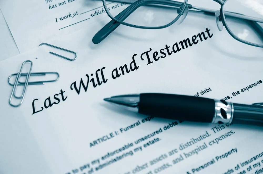Last Will and Testament Document with Paperclips, Eyeglasses and Pen